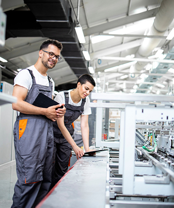 men standing next to a machine